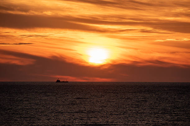 Cargo ship on the sea at beautiful sunset