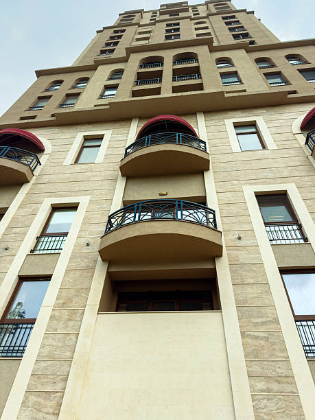 istock Building with balconies and windows in urban area under cloudy sky at evening 2255537110