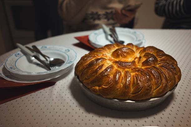 Traditional serving of food during Christmas in Serbia, breaking Cesnica bread from family members.