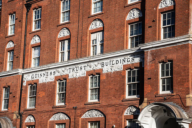 London, England, United Kingdom — 7 January 2026: Exterior view of Guinness Trust residential buildings on Fulham Palace Road, Hammersmith, showcasing brick facades and traditional London housing design in the London Borough of Hammersmith & Fulham.