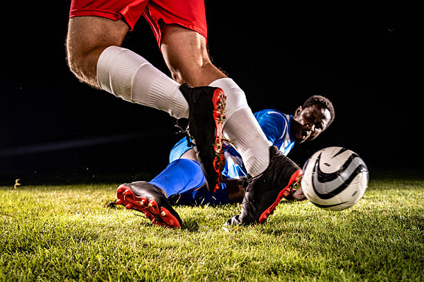 istock Soccer Player in Red Shorts Controlling Ball 2255542635