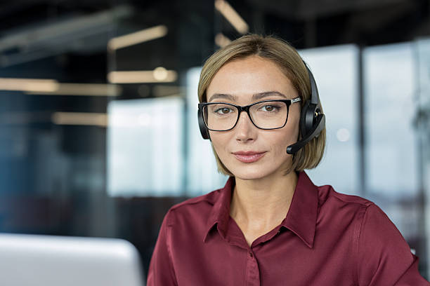 istock Friendly woman operator wearing headset providing customer service 2255545132