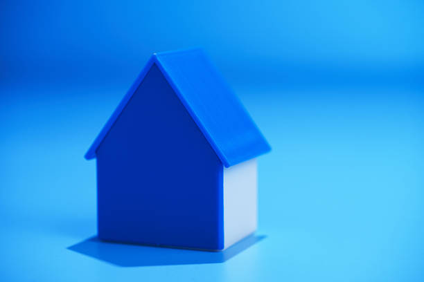 Cupped hands holding a house.
