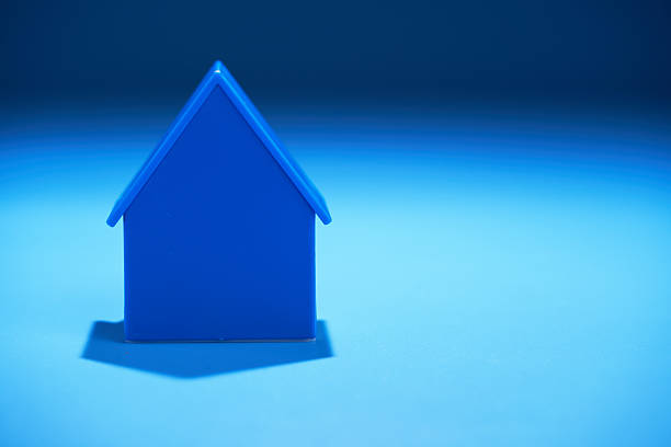 small blue house model against blue background