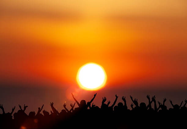 A group of people celebrates the sunset