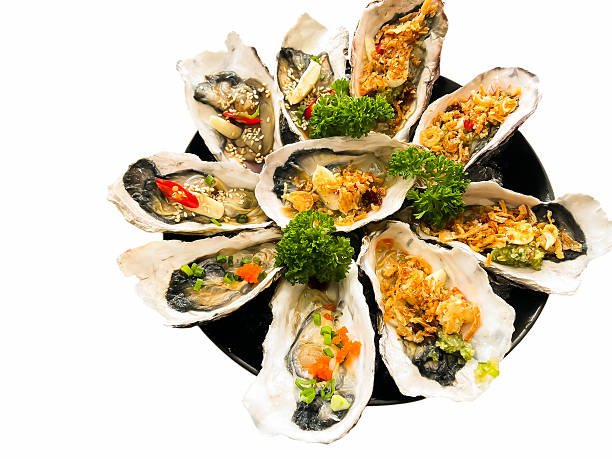 Enjoying sea food with asian sauce fresh oysters and spicy thai food deep fired squid and other in south of thailand
