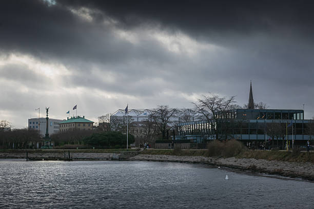 Urban scene with victory statue, flags, and moody light in Denmark