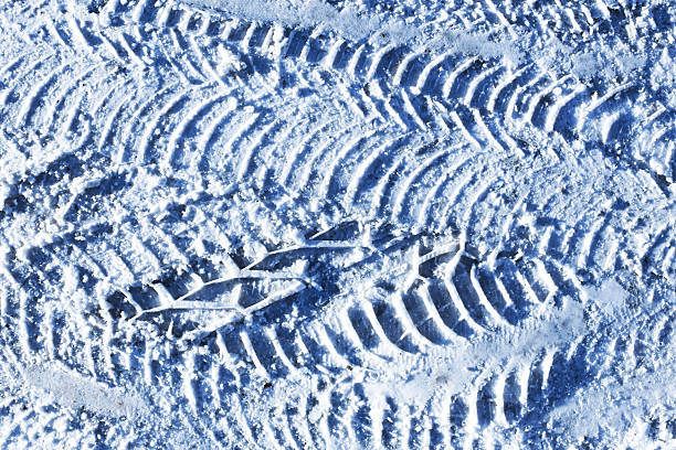 Cold weather texture background. Frozen ground detail. Driving in winter conditions.