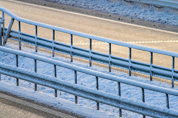 Snowy roadside guardrail along winter highway