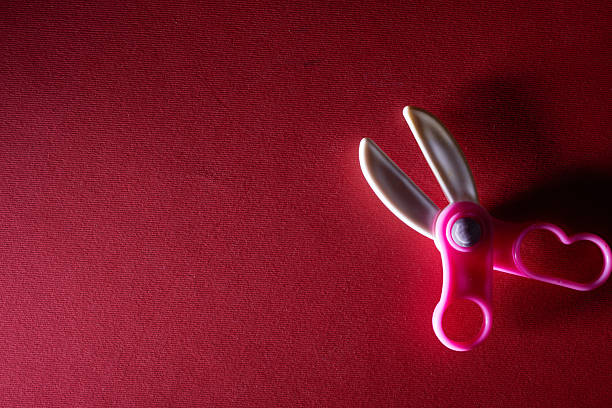 toy plastic sicssors on red background