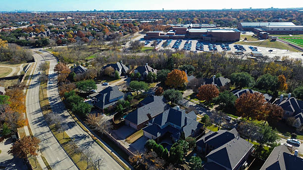 istock Image aligns with the divided parkway road, highlighting how it bisects the community. It captures the transition from luxury homes into the vast academic and athletic grounds, Coppell, Texas 2255570569