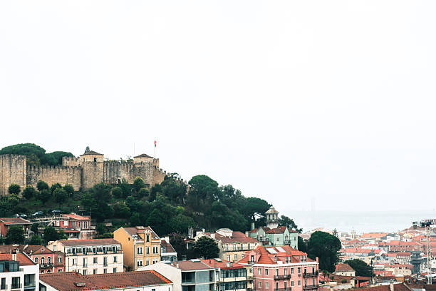 A panoramic view of Lisbon s historic hillside with colorful houses, red tiled roofs.