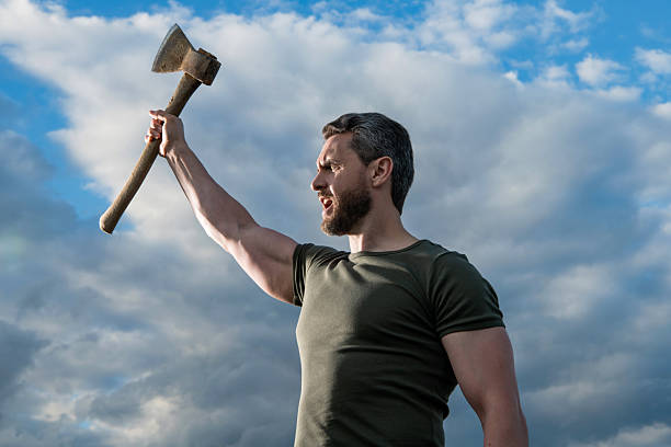 istock confident man with axe. strong caucasian man hold ax. brutal man on sky background 2255578168