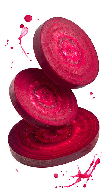 Fresh beetroot slices floating with juice splashes