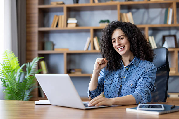 istock Happy woman celebrating success while working on laptop 2255587266