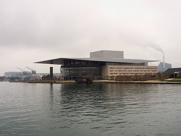 Contemporary opera house with distinctive architecture situated along harbor waterfront, Copenhagen, Denmark