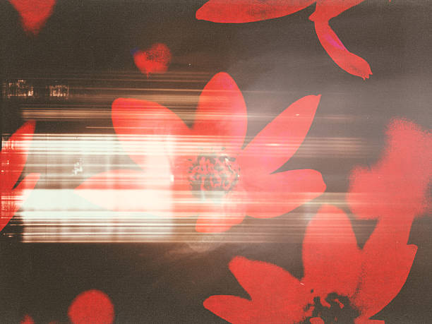 A dynamic, motion-blurred abstract shot of red floral patterns on the dark background, capturing energy and movement with a high-contrast, moody aesthetic. A bold, artistic design. Print advertising.