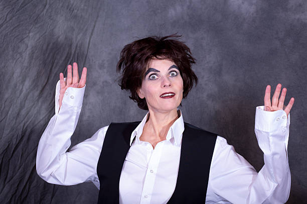 Woman posing with both hands raised.