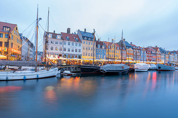 Copenhagen, Nyhavn A city street with a canal running through it