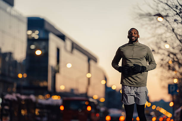 Man jogging city street during evening workout