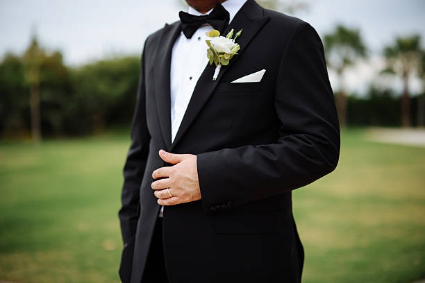 A groom preparing to marry the love of his life. Close up of businessman wearing cufflinks. Elegant young fashion business man wearing suit