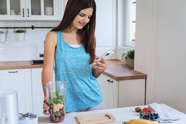 istock Preparing a Fresh Berry Smoothie in a Modern Kitchen 2255599241