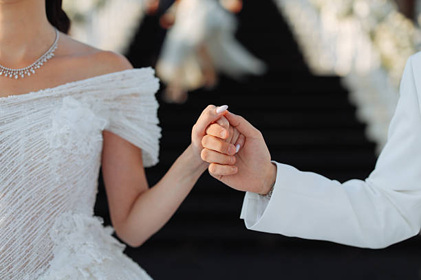 groom's hand embraces the bride on the wedding day during the festive ceremony