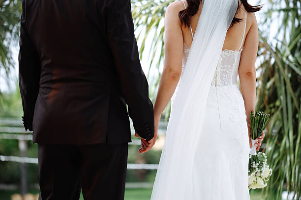 Happy bride and groom on their wedding hugging. Closeup Bride holding a bouquet