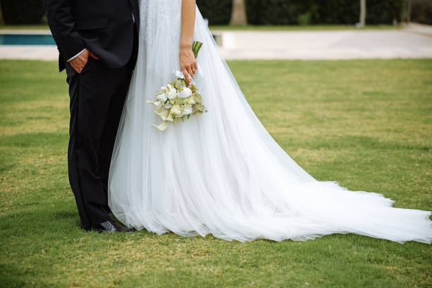 Happy bride and groom on their wedding hugging. Closeup Bride holding a bouquet