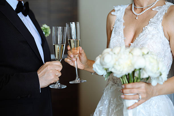 istock Bride And Groom Toasting Champagne Flutes 2255602098