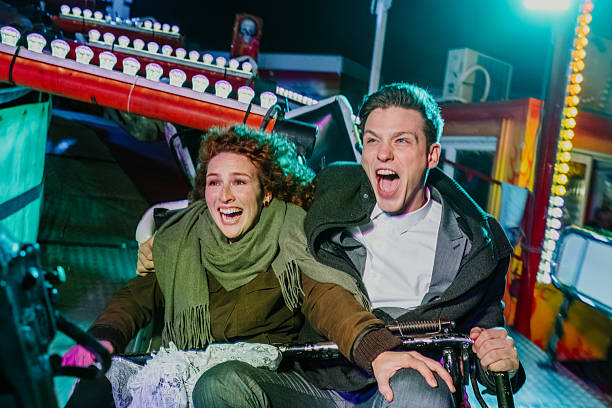 istock Young couple screaming while riding roller coaster at fairground 2255605967