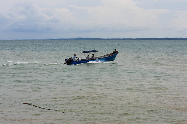 Passengers ride aboard a small motorboat traveling along the coast of Isla Fuerte, Colombia, in November 2025. Small boats are a primary means of mobility on the island, connecting beaches, docks, and nearby coastal areas.