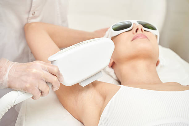istock Female receiving laser hair removal treatment in spa setting with protective 2255608654