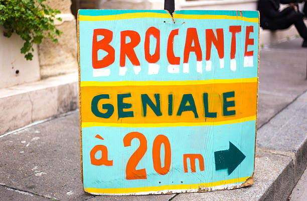 Paris, France: A colorful sign advertising a “great flea market in 20 meters”  (brocante geniale à 20 m).
