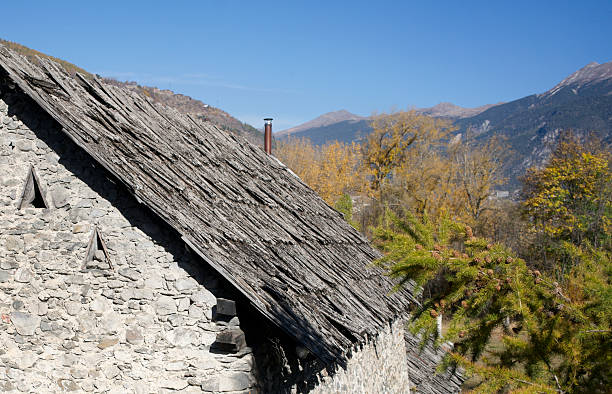 Frayed wooden roof shingles in the Alps