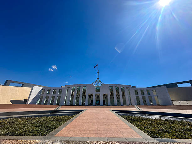 Canberra Australia January 23 2011;  Three tourists of Indian ethnicity standing for photo in forecourt of Australian Parliment buiding.