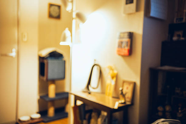 A quiet living room interior illuminated by warm ambient light, photographed with soft focus and shallow depth of field. The cozy atmosphere suggests a peaceful everyday moment, suitable for themes of home, comfort, solitude, lifestyle, and emotional calm.