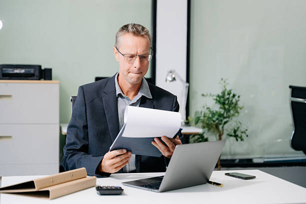 istock Mature business man executive manager looking at laptop watching online webinar training or having virtual meeting 2255637404