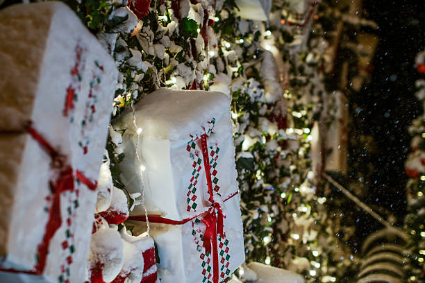 Christmas tree with colorful gift boxes covered in fresh white snow during winter holiday season