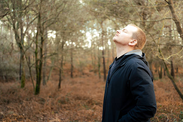 istock Man breathing fresh air enjoying nature in forest 2255639068