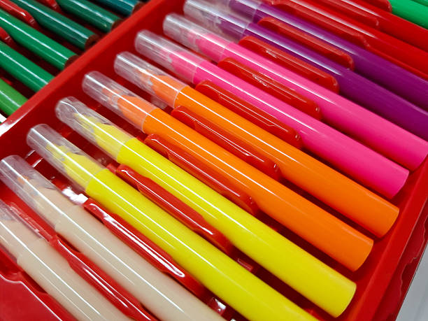 Set of assorted colorful markers scattered on a desk ready for art projects and illustrations.