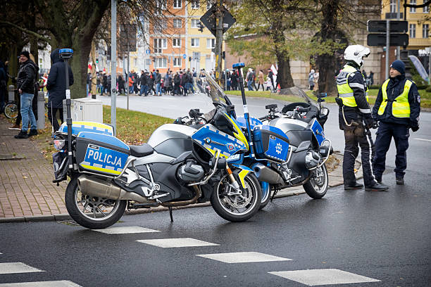 Two police officers with motorcycles stand at an intersection on November 11 in Szczecin, West Pomeranian Voivodeship, Poland