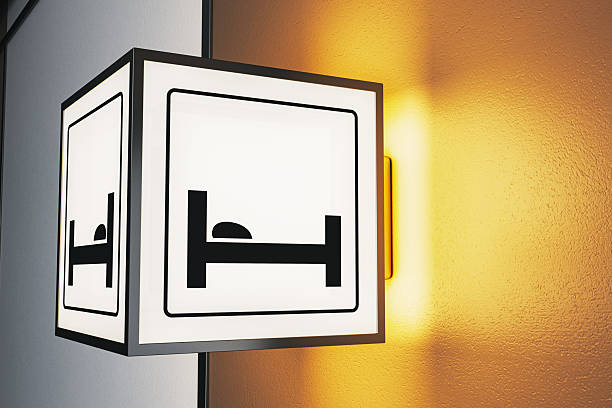 Illuminated hotel sign with bed icon, modern graphic style, mounted on textured wall background, concept of creative hospitality signage, 3D Rendering
