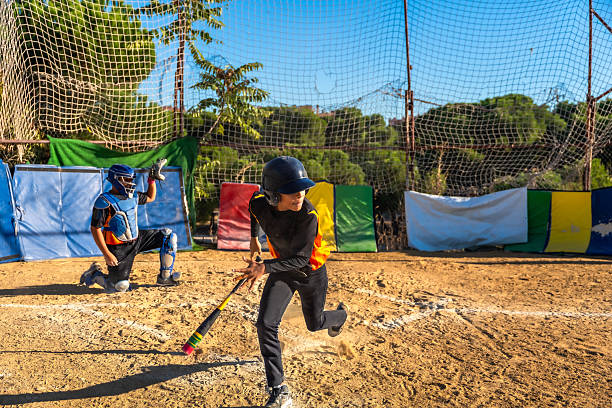a boy hitting a baseball