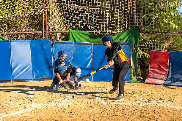 baseball compressed on baseball bat with boy little league player swinging