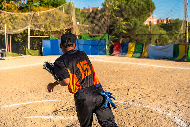 Slide, softball action and player in match or game for sports competition on a pitch in a stadium. Goal, ground and  tournament performance by athlete or base runner in training, exercise or workout