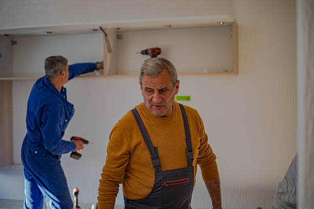 istock Placing furniture in an apartment, carpenters assembling a shelf 2255647222