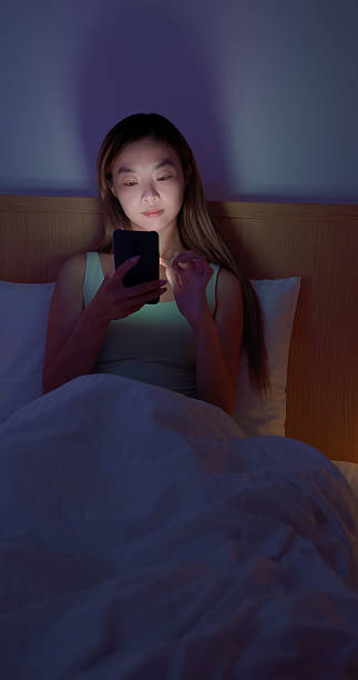 istock Asian woman scroll smartphone on bed night 2255650120