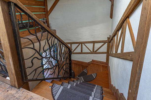 A staircase with a traditional green carpet on it