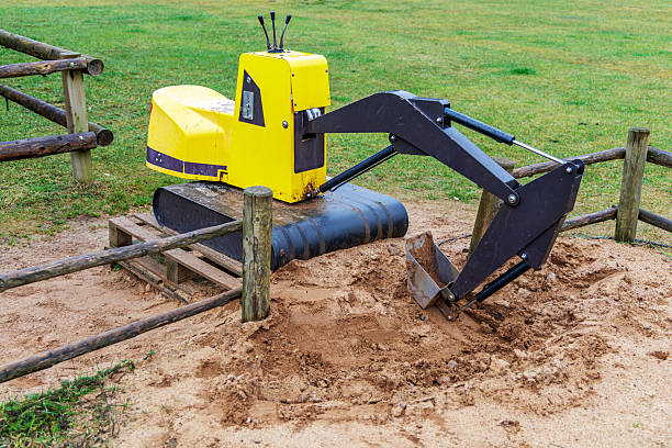 Kid Asian baby boy todler playing construction truck toy digging sand in playground